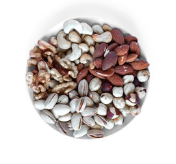 Healthy food. Nuts mix assortment on white grey table top view. Collection of different legumes for background image close up nuts, pistachios, almond, cashew nuts, peanut, walnut. image