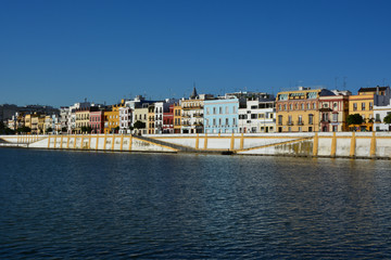 Fototapeta na wymiar The colorful and picturesque district of Triana on the banks of the Guadalquivir river, in Seville, Spain