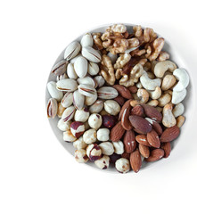 Healthy food. Nuts mix assortment on white grey table top view. Collection of different legumes for background image close up nuts, pistachios, almond, cashew nuts, peanut, walnut. image