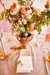 Vintage wedding decor. Beautiful event venue. Creative decoration. Pink and gold color. Wedding calligraphy menu