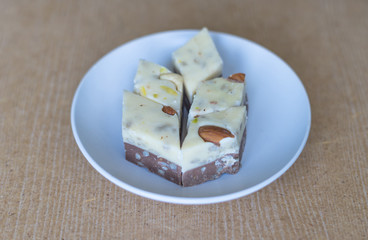 Traditional Turkish Delight. Oriental dessert halva on a  plate. Isolated on background. Eastern...
