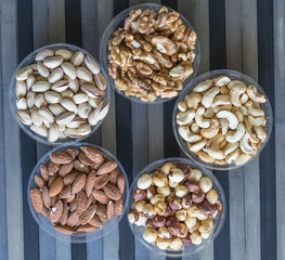 Healthy food. Nuts mix assortment on stone texture top view. Collection of different legumes for background image close up nuts, pistachios, almond, cashew nuts, peanut, walnut. image