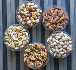 Healthy food. Nuts mix assortment on stone texture top view. Collection of different legumes for background image close up nuts, pistachios, almond, cashew nuts, peanut, walnut. image