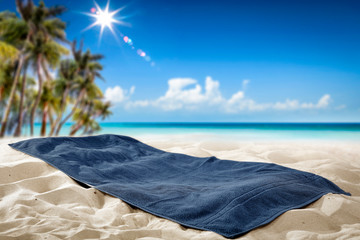 Summer towel on sand and beach background. 