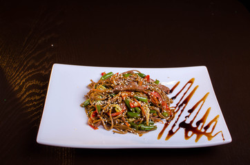 Traditional asian dish. Noodles with beef and vegetables. Restaurant dish