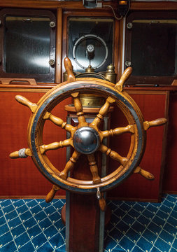 Old boat, steering wheel from brass and wood. Ship rudder. Sailboat helm
