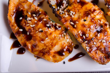 Menu of Ukrainian seafood restaurant. Baked mussels with garlic and cheese. Poured with sauce and sprinkled with sesame. Tasty lunch