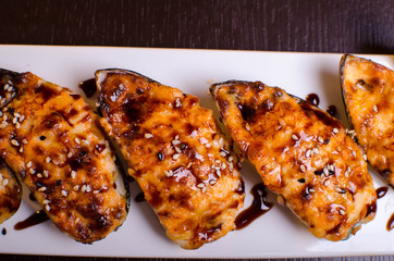Menu of Ukrainian seafood restaurant. Baked mussels with garlic and cheese. Poured with sauce and sprinkled with sesame. Tasty lunch