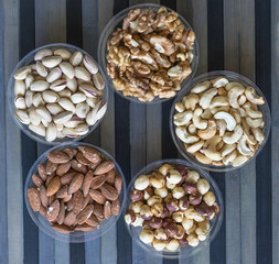Healthy food. Nuts mix assortment on stone texture top view. Collection of different legumes for background image close up nuts, pistachios, almond, cashew nuts, peanut, walnut. image