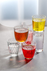 Various lemonades in glass faceted glasses.