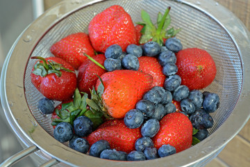 Fresh Strawberry and blueberry in Metal colander