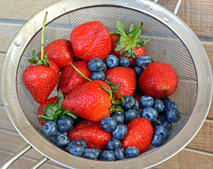 Fresh Strawberry and blueberry in Metal colander