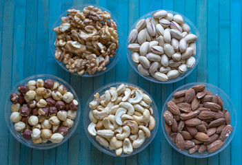 Healthy food. Nuts mix assortment on stone texture top view. Collection of different legumes for background image close up nuts, pistachios, almond, cashew nuts, peanut, walnut. image