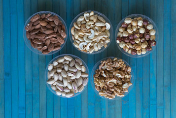 Healthy food. Nuts mix assortment on stone texture top view. Collection of different legumes for background image close up nuts, pistachios, almond, cashew nuts, peanut, walnut. image