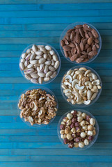Healthy food. Nuts mix assortment on stone texture top view. Collection of different legumes for background image close up nuts, pistachios, almond, cashew nuts, peanut, walnut. image