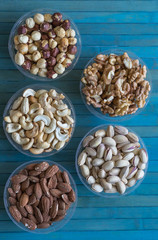 Healthy food. Nuts mix assortment on stone texture top view. Collection of different legumes for background image close up nuts, pistachios, almond, cashew nuts, peanut, walnut. image