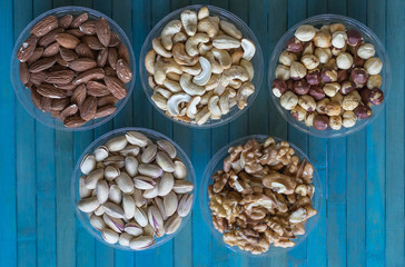Healthy food. Nuts mix assortment on stone texture top view. Collection of different legumes for background image close up nuts, pistachios, almond, cashew nuts, peanut, walnut. image