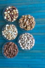 Healthy food. Nuts mix assortment on stone texture top view. Collection of different legumes for background image close up nuts, pistachios, almond, cashew nuts, peanut, walnut. image