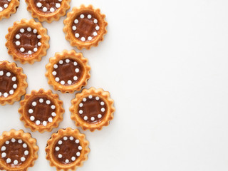 Cookies with caramel on white background. Top view or flat lay. Copyspace. Food background