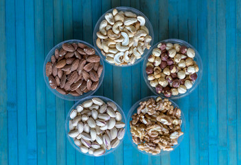Healthy food. Nuts mix assortment on stone texture top view. Collection of different legumes for background image close up nuts, pistachios, almond, cashew nuts, peanut, walnut. image