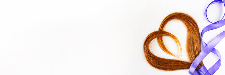 long blond hair donation put like heart with lavender ribbon as symbol of fight against cancer on white background. Top view. Natural material for making wig for patients. Horizontal banner copy space