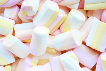 Pink, yellow white pastel color marshmallows background
