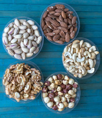 Healthy food. Nuts mix assortment on stone texture top view. Collection of different legumes for background image close up nuts, pistachios, almond, cashew nuts, peanut, walnut. image