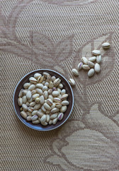 Healthy food  for background image close up pistachios nuts. Texture on top view Nuts pistachio on the cup plate