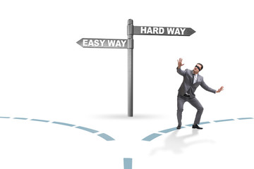 Businessman choosing between hard and easy way