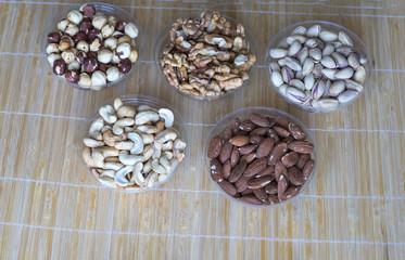 Healthy food. Nuts mix assortment on stone texture top view. Collection of different legumes for background image close up nuts, pistachios, almond, cashew nuts, peanut, walnut. image