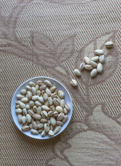 Healthy food  for background image close up pistachios nuts. Texture on top view Nuts pistachio on the cup plate