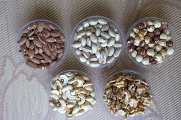 Healthy food. Nuts mix assortment on stone texture top view. Collection of different legumes for background image close up nuts, pistachios, almond, cashew nuts, peanut, walnut. image