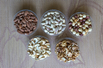 Healthy food. Nuts mix assortment on stone texture top view. Collection of different legumes for background image close up nuts, pistachios, almond, cashew nuts, peanut, walnut. image