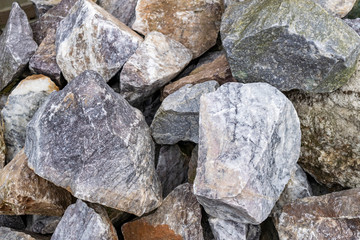 Background from natural materials of rough texture. Gray stone background from rock stones close-up.