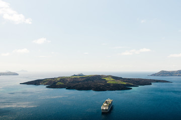 Seascape of the island of Nea Kameni volcano in Santorini, Greece.