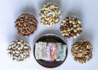 Traditional Turkish Delight. Oriental dessert on a  plate. Isolated on white background. Eastern delicacy sweets. Healthy food mix assortment. Collection of different for image close up top view