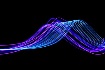 Long exposure, light painting photography.  Vibrant waves of neon electric blue and purple in parallel lines against a black background.