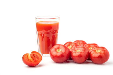 Tomato juice in a glass, with tomatoes on a white background