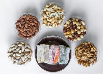 Traditional Turkish Delight. Oriental dessert on a  plate. Isolated on white background. Eastern delicacy sweets. Healthy food mix assortment. Collection of different for image close up top view