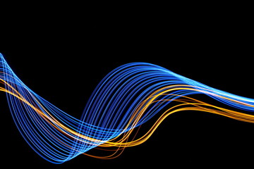 Long exposure, light painting photography.  Vibrant streaks of neon electric blue and metallic...
