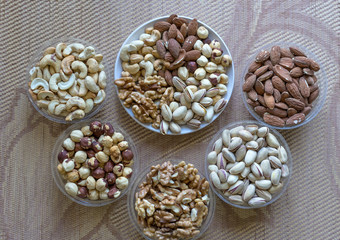 Healthy food. Nuts mix assortment on texture top view. Collection of different legumes for background image close up nuts, pistachios, almond, cashew nuts, peanut, walnut. image