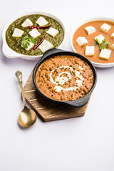Palak paneer butter masala, yellow dal or dal-makhani served in a bowl in a group. selective focus