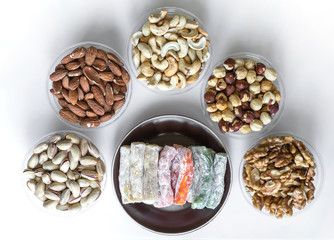 Traditional Turkish Delight. Oriental dessert on a  plate. Isolated on white background. Eastern delicacy sweets. Healthy food mix assortment. Collection of different for image close up top view