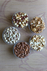 Healthy food. Nuts mix assortment on stone texture top view. Collection of different legumes for background image close up nuts, pistachios, almond, cashew nuts, peanut, walnut. image