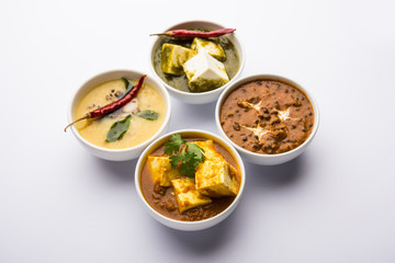 Palak paneer butter masala, yellow dal or dal-makhani served in a bowl in a group. selective focus