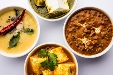 Palak paneer butter masala, yellow dal or dal-makhani served in a bowl in a group. selective focus