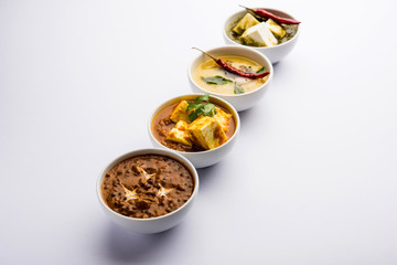 Palak paneer butter masala, yellow dal or dal-makhani served in a bowl in a group. selective focus