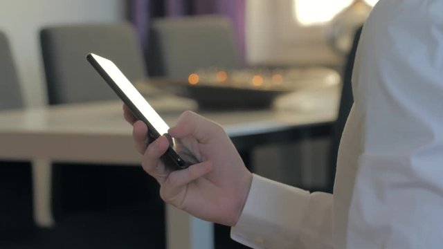 businessman typing sms mms on a smartphone