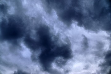 Dark forming clouds with blue sky elements right before a thunderstorm