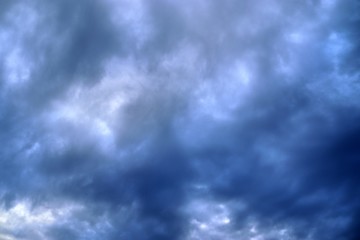 Dark forming clouds with blue sky elements right before a thunderstorm